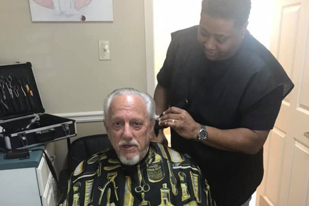 Gardens of Savannah resident getting haircut