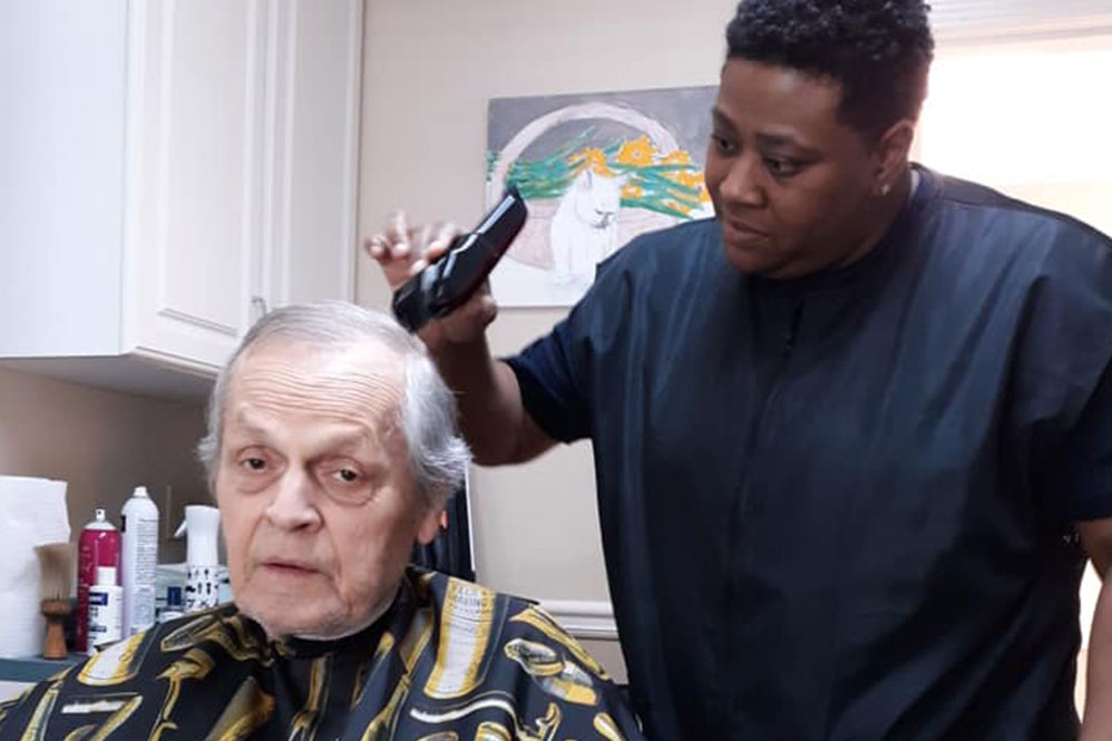 Gardens of Savannah resident getting haircut
