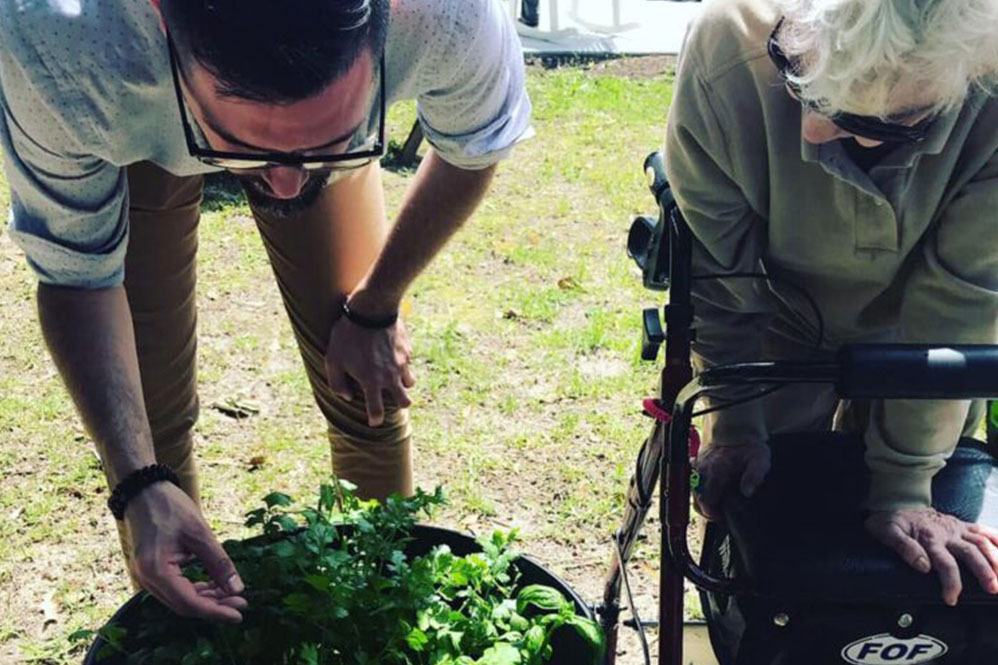 Gardens of Savannah resident and staff member gardening