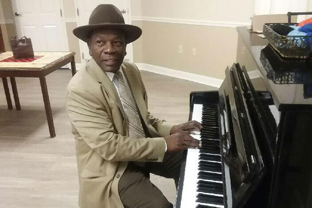 Gardens of Savannah resident playing piano